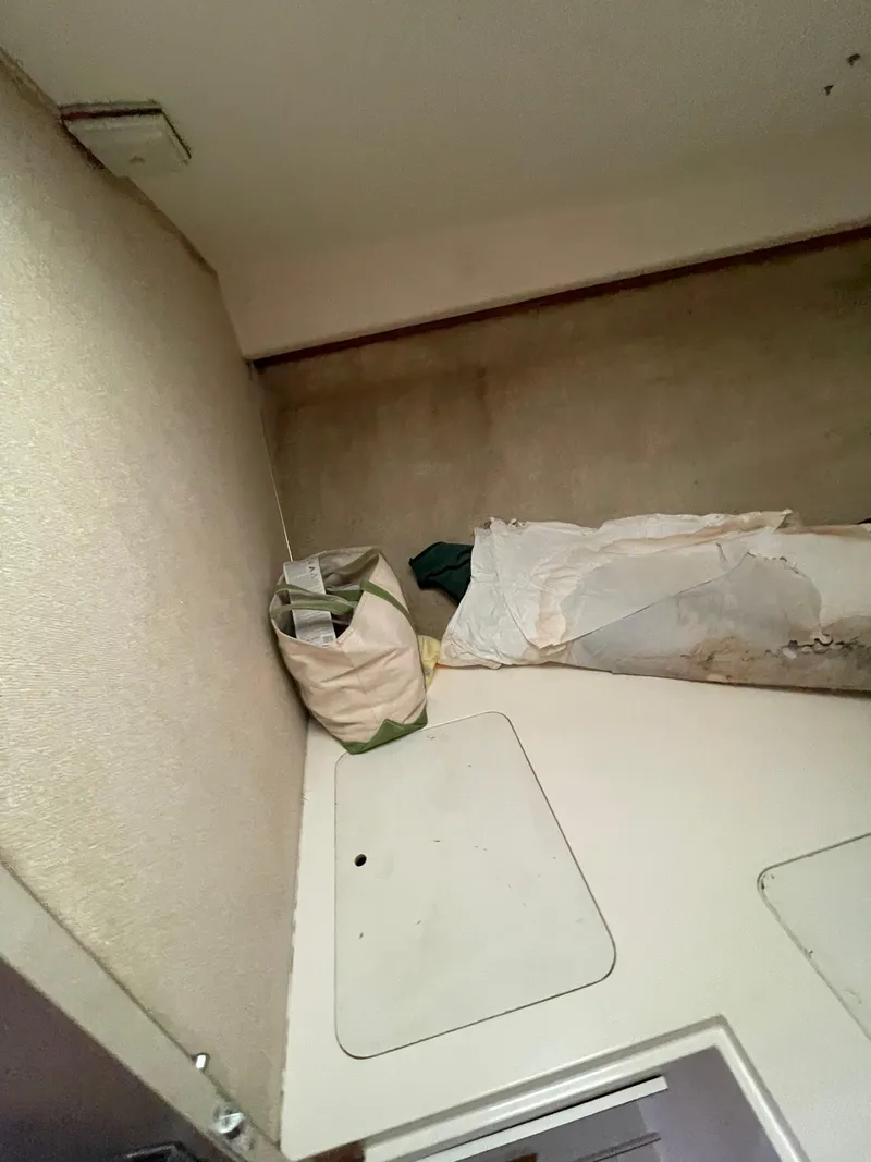 Slide: The Image of Interior cabin of a 1978 Bertram 33 Flybridge Cruiser with bedding and storage. - 24