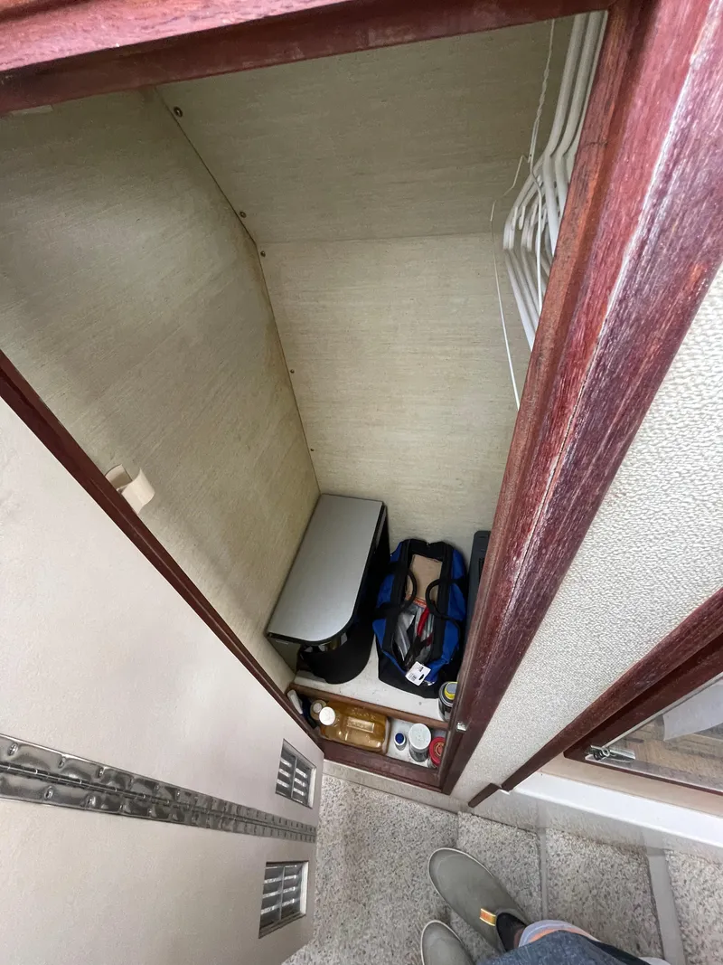 Slide: The Image of 1978 Bertram 33 Flybridge Cruiser interior storage space with various items. - 26