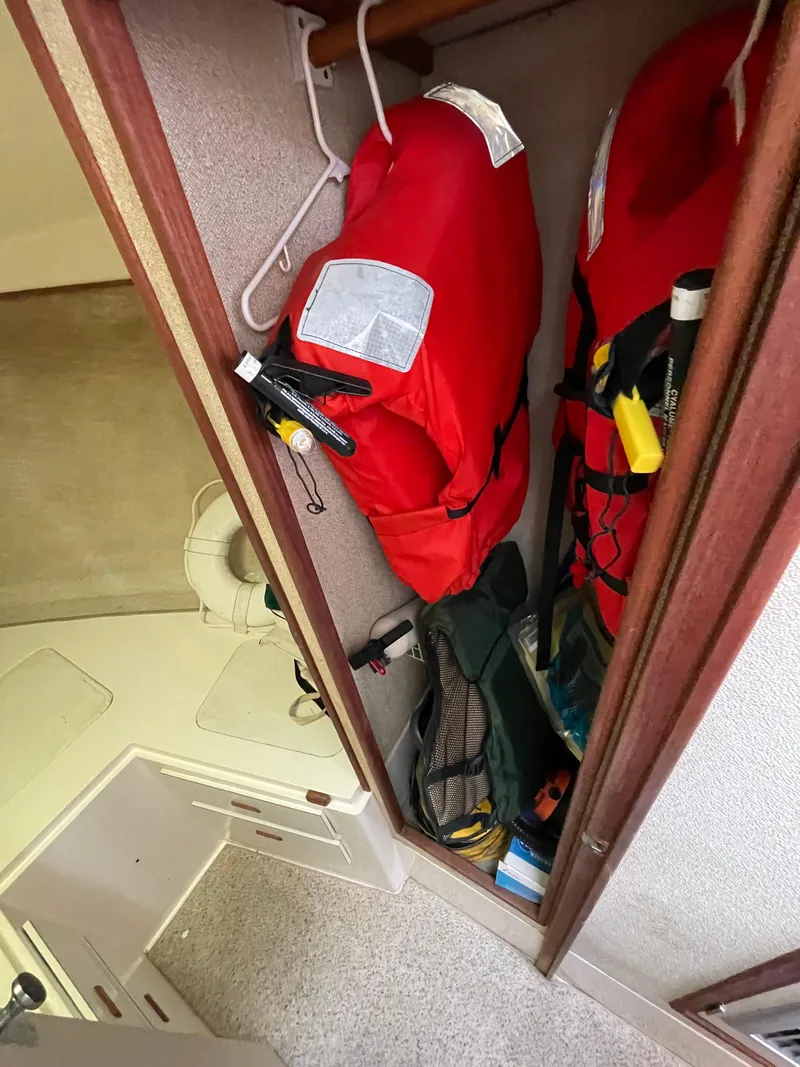 Slide: The Image of Storage area with life jackets on a 1978 Bertram 33 Flybridge Cruiser. - 27