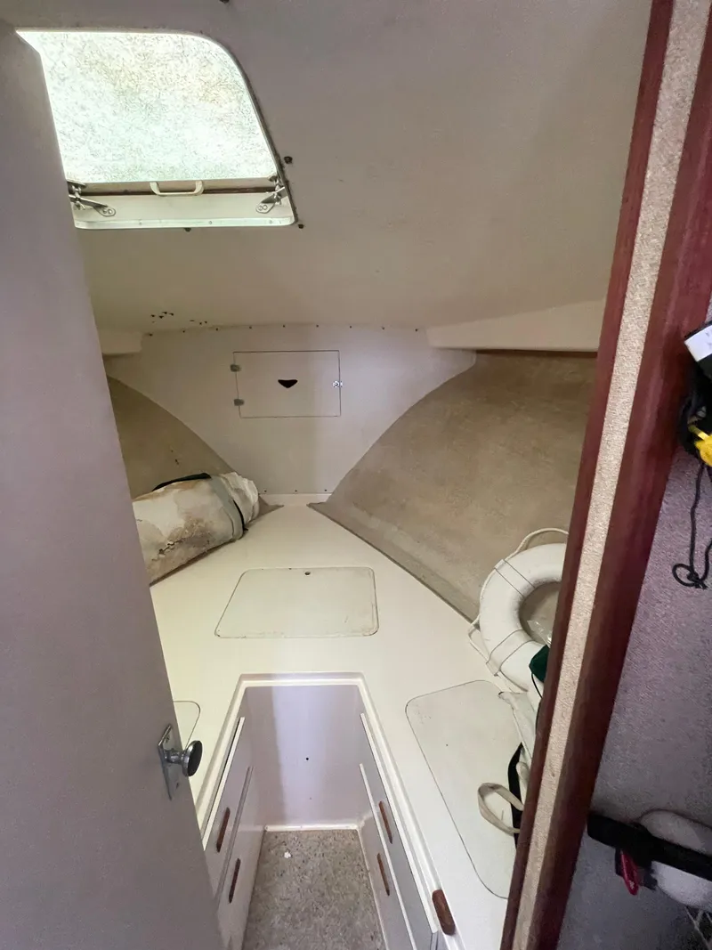 Slide: The Image of 1978 Bertram 33 Flybridge Cruiser cabin interior with bed and storage. - 28