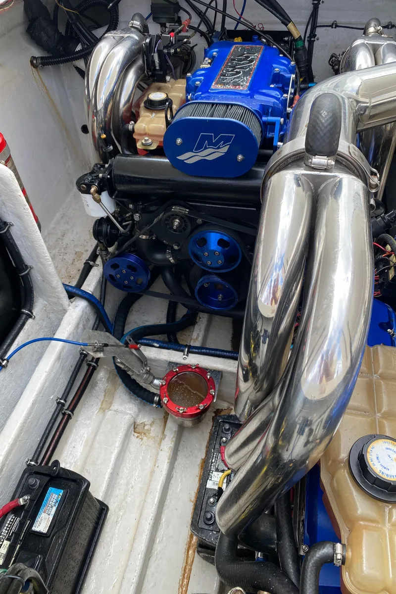 Slide: The Image of Engine of a 2006 Fountain 42 Executioner boat with blue and chrome components. - 14