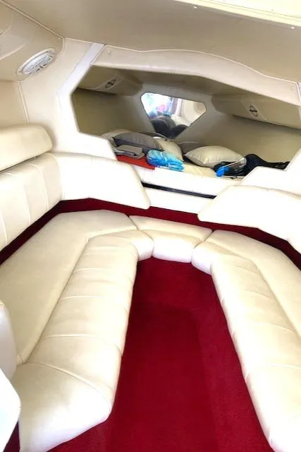 Slide: The Image of 2006 Fountain 42 Executioner cabin with white leather seating and red carpet. - 4