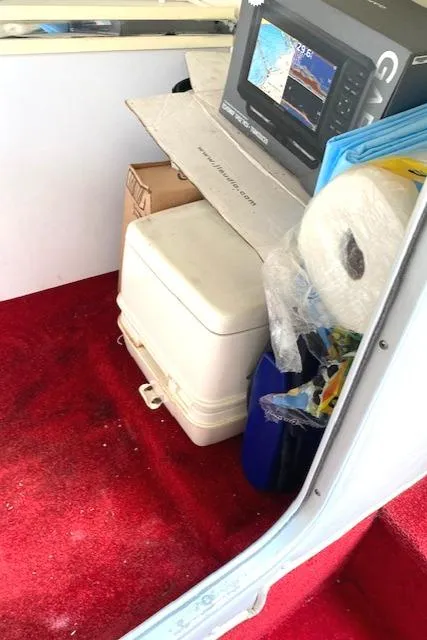 Slide: The Image of Interior of a 2006 Fountain 42 Executioner with red carpet and marine equipment. - 8