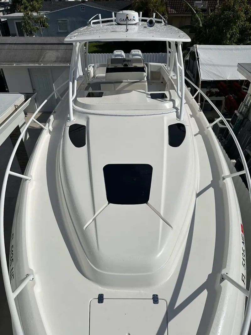Slide: The Image of 2005 Intrepid 355 boat with sleek white deck and modern design. - 2