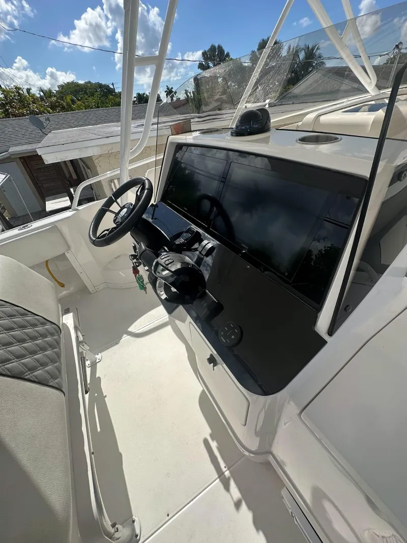 Slide: The Image of 2005 Intrepid 355 boat cockpit with steering wheel and control panel. - 3
