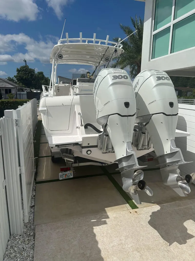 Slide: The Image of 2005 Intrepid 355 boat with twin 300 horsepower engines docked beside a house. - 6