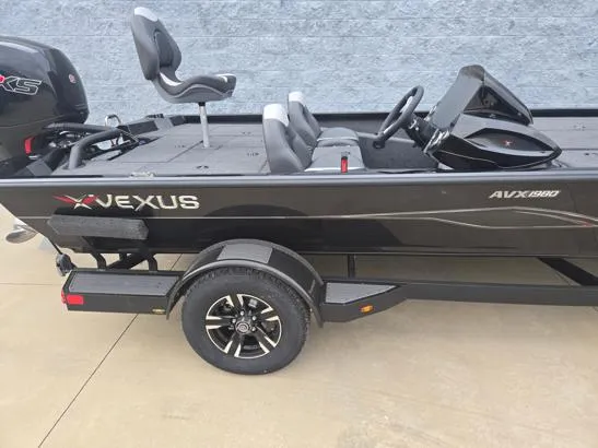 Slide: The Image of 2025 Vexus AVX1980 boat with sleek black design and modern seating on a trailer. - 7
