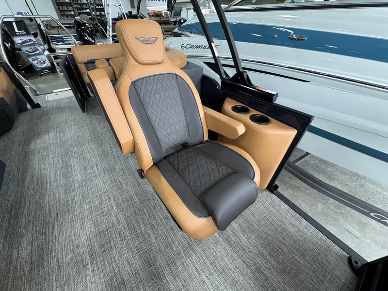 Slide: The Image of Luxurious seating in the 2025 Bennington 24 MFB boat, featuring tan and gray upholstery. - 11