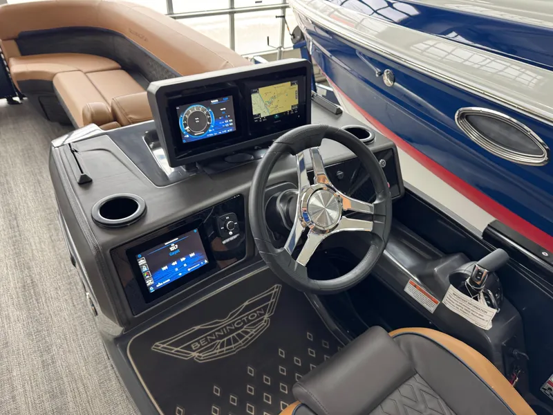 Slide: The Image of 2025 Bennington 24 MFB boat dashboard with modern navigation screens and steering wheel. - 4