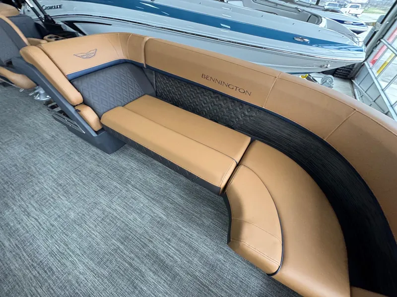 Slide: The Image of 2025 Bennington 24 MFB boat interior with tan leather seating and elegant design. - 9