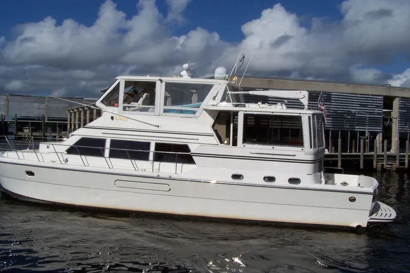 Slide: The Image of 2004 Novatec Islander CPMY yacht on water, under a partly cloudy sky. - 14