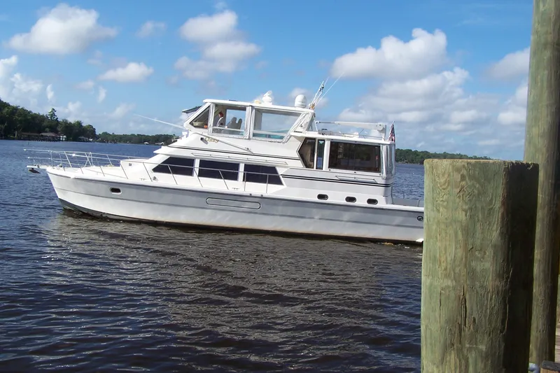Slide: The Image of 2004 Novatec Islander CPMY yacht on calm water under a blue sky. - 15