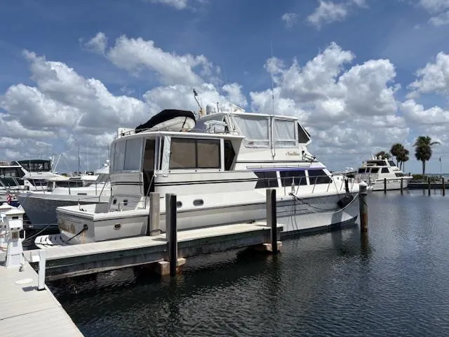 Slide: The Image of 2004 Novatec Islander CPMY yacht docked at marina under blue sky. - 24