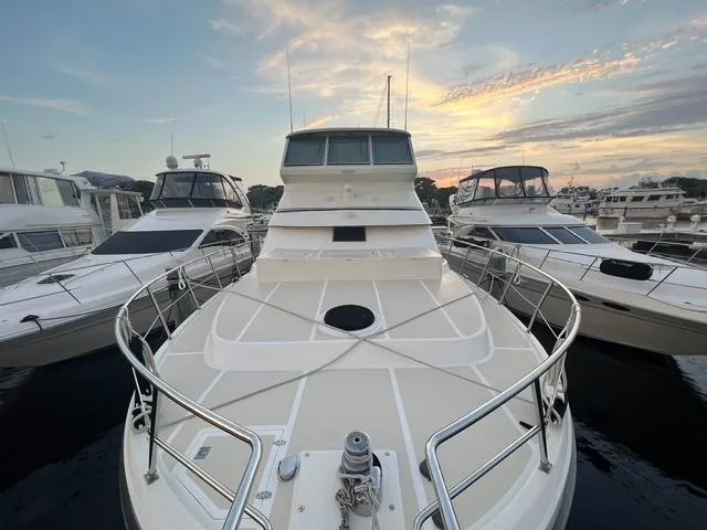 Slide: The Image of 2004 Novatec Islander CPMY yacht docked at sunset, surrounded by other boats. - 25