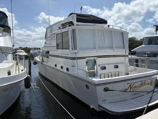 Slide: The Image of 2004 Novatec Islander CPMY yacht docked at marina under a partly cloudy sky. - 26