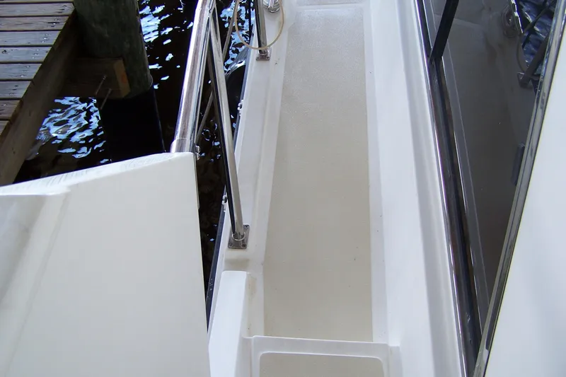 Slide: The Image of 2004 Novatec Islander CPMY yacht deck with railing and dock view. - 28