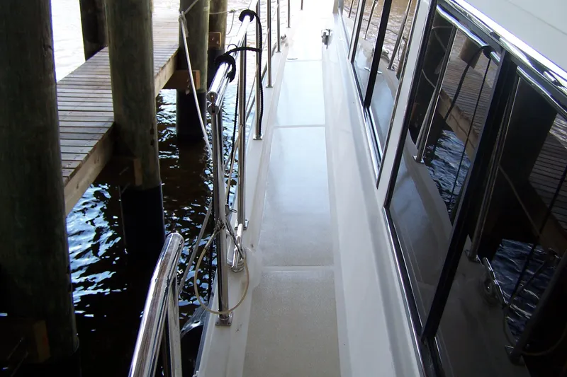 Slide: The Image of 2004 Novatec Islander CPMY yacht docked, showing side deck and railing. - 35