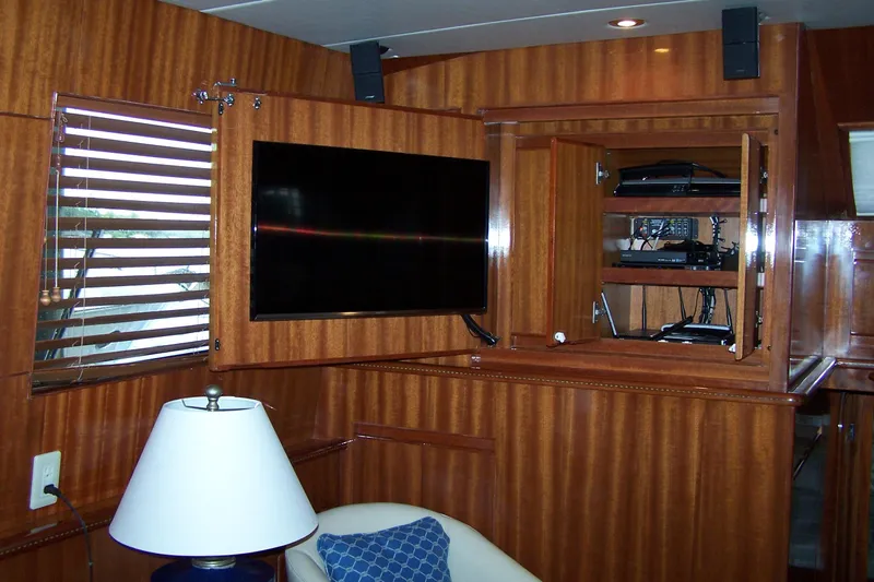 Slide: The Image of Interior of 2004 Novatec Islander CPMY yacht with TV, wooden paneling, and electronics cabinet. - 39
