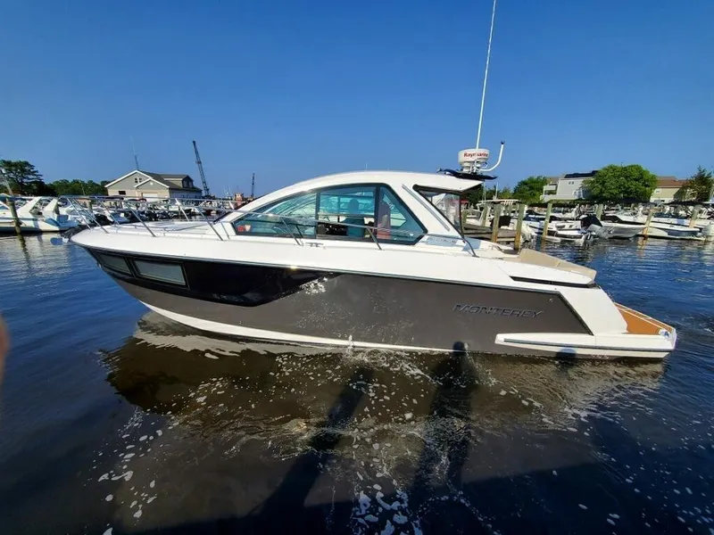 The Image of 2017 Monterey 360 Sport Coupe docked by waterfront homes. - 0
