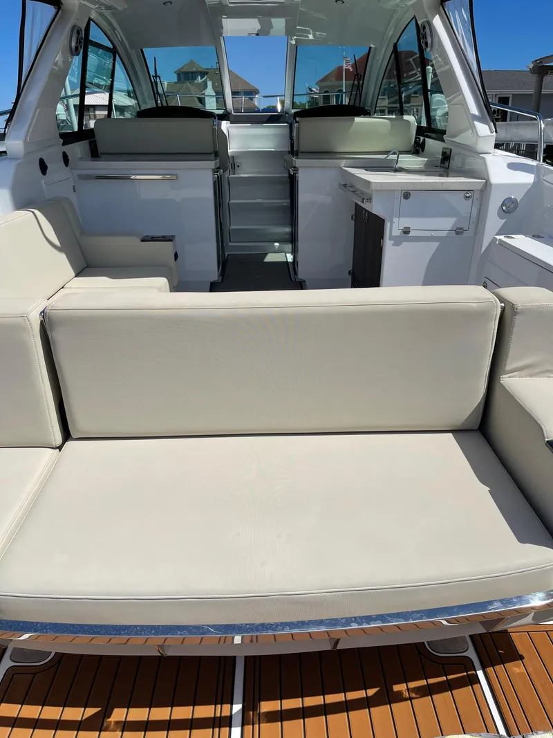 Slide: The Image of 2017 Monterey 360 Sport Coupe boat interior with open storage compartment and seating area. - 15