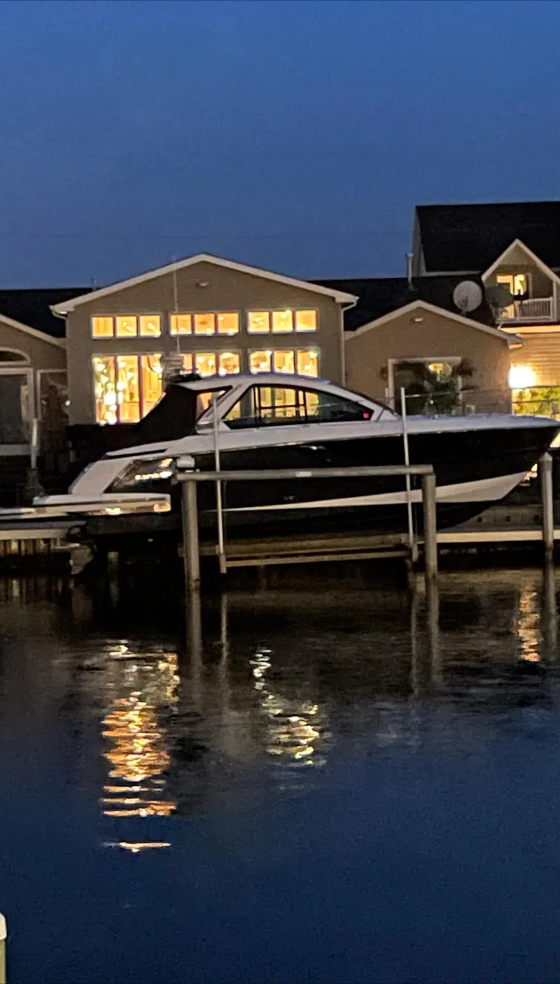 Slide: The Image of 2017 Monterey 360 Sport Coupe boat with beige seating, cruising on a lake. - 20