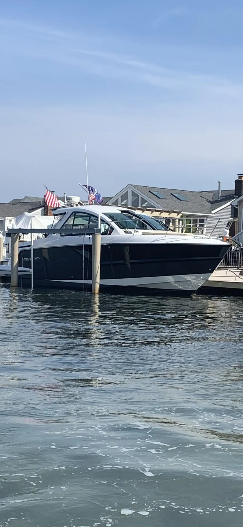 Slide: The Image of 2017 Monterey 360 Sport Coupe cruising at sunset with illuminated seating and ocean view. - 21