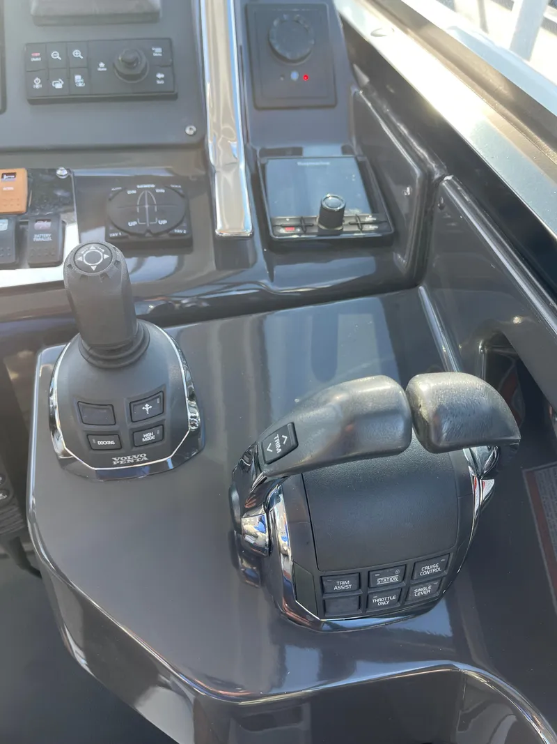 Slide: The Image of Control panel of a 2017 Monterey 360 Sport Coupe boat, featuring joystick and throttle controls. - 22