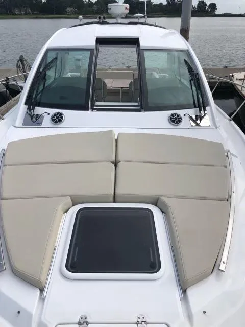 Slide: The Image of 2017 Monterey 360 Sport Coupe boat with beige sunbathing cushions on deck. - 26