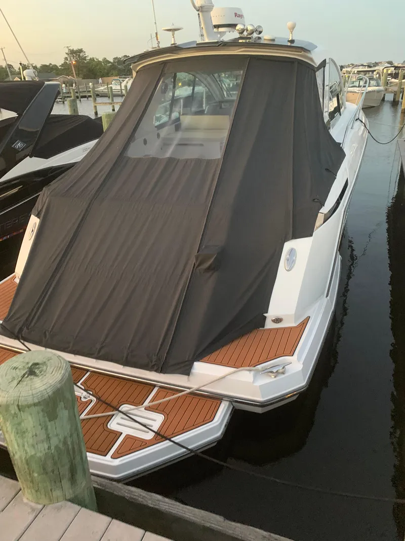 Slide: The Image of 2017 Monterey 360 Sport Coupe docked, featuring a covered deck and sleek design. - 27