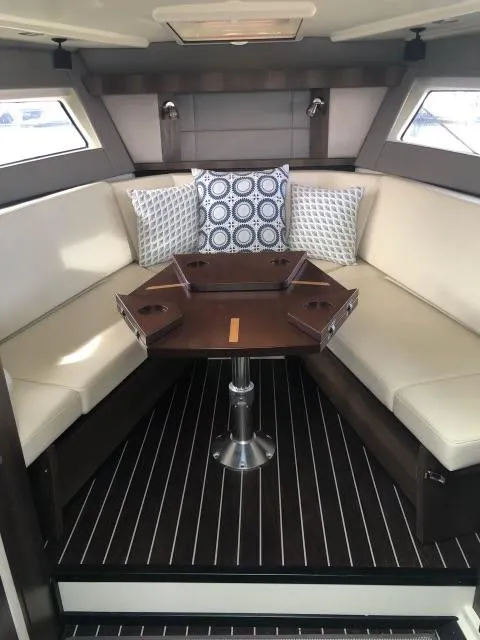 Slide: The Image of 2017 Monterey 360 Sport Coupe interior with elegant seating and stylish wooden table. - 29