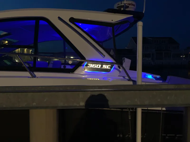 Slide: The Image of 2017 Monterey 360 Sport Coupe boat docked in marina under clear blue sky. - 3