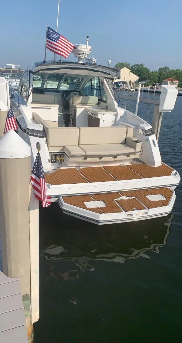 Slide: The Image of 2017 Monterey 360 Sport Coupe with blue LED lights docked at night. - 4