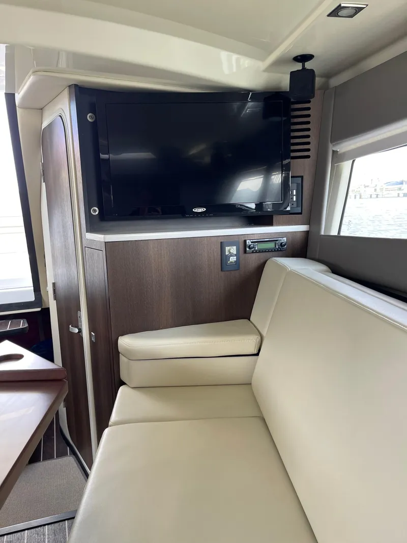 Slide: The Image of 2017 Monterey 360 Sport Coupe boat illuminated at night with blue interior lighting. - 5