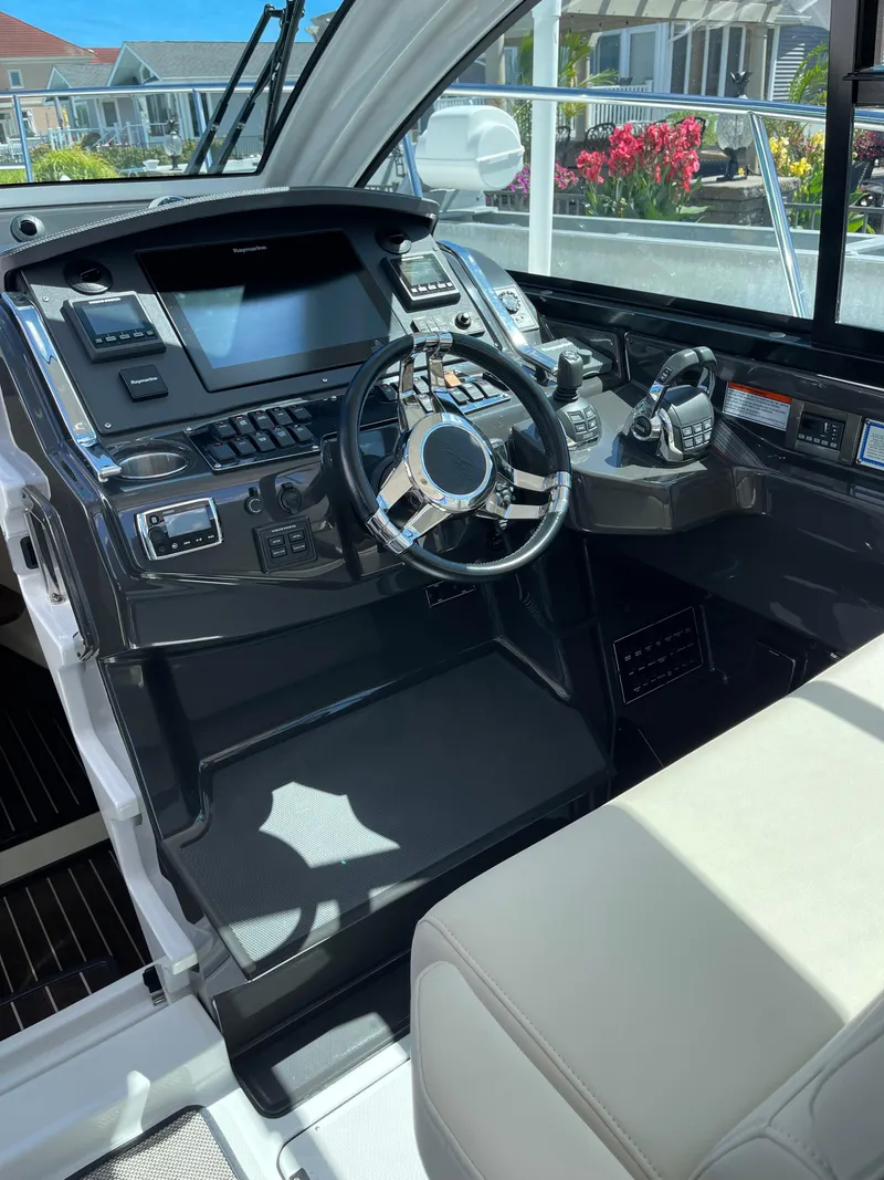 Slide: The Image of 2017 Monterey 360 Sport Coupe yacht interior with kitchenette and stainless steel appliances. - 8