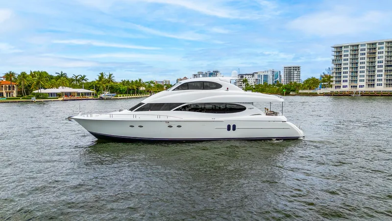 Slide: The Image of 2002 Lazzara 80 Skylounge yacht cruising on a scenic waterway. - 10