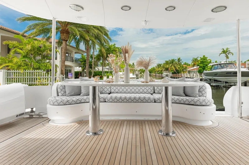 Slide: The Image of Luxurious 2002 Lazzara 80 Skylounge yacht deck with elegant seating and scenic waterfront view. - 12