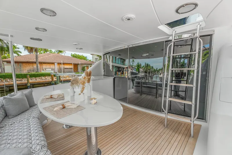 Slide: The Image of Luxurious 2002 Lazzara 80 Skylounge yacht deck with elegant seating and dining area. - 13