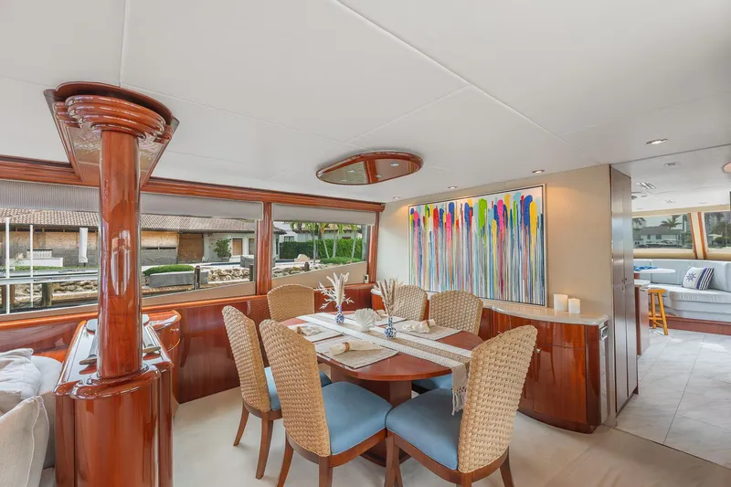 Slide: The Image of Luxurious dining area on 2002 Lazzara 80 Skylounge yacht with modern art and elegant furnishings. - 17