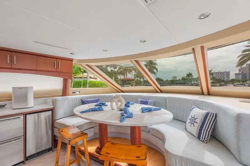 Slide: The Image of Luxurious interior of 2002 Lazzara 80 Skylounge yacht with panoramic windows and elegant dining area. - 21