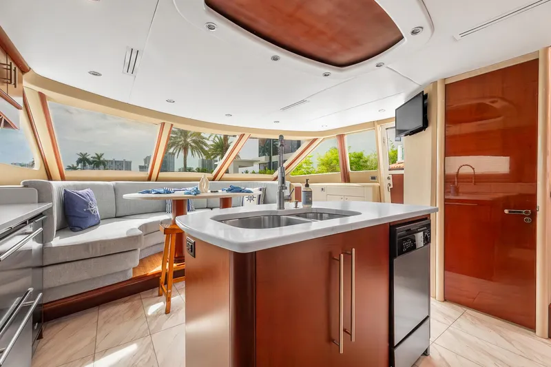 Slide: The Image of Luxurious interior of 2002 Lazzara 80 Skylounge yacht with modern kitchen and seating area. - 22