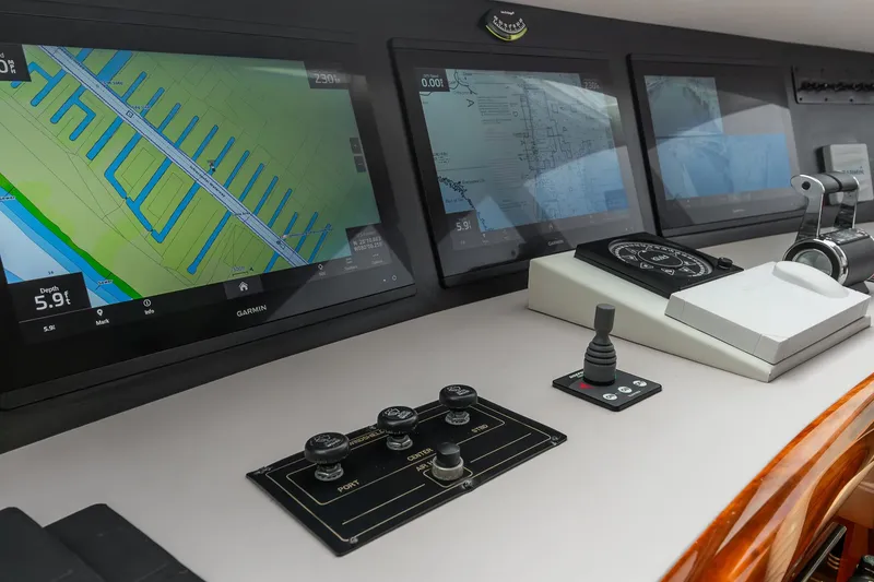 Slide: The Image of Control panel of 2002 Lazzara 80 Skylounge yacht with navigation screens and controls. - 26