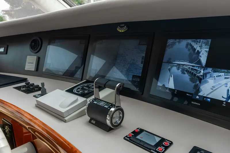 Slide: The Image of Control panel of 2002 Lazzara 80 Skylounge yacht with navigation screens and controls. - 27