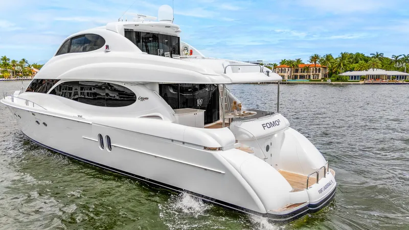 Slide: The Image of Luxury 2002 Lazzara 80 Skylounge yacht cruising on a scenic waterway. - 3