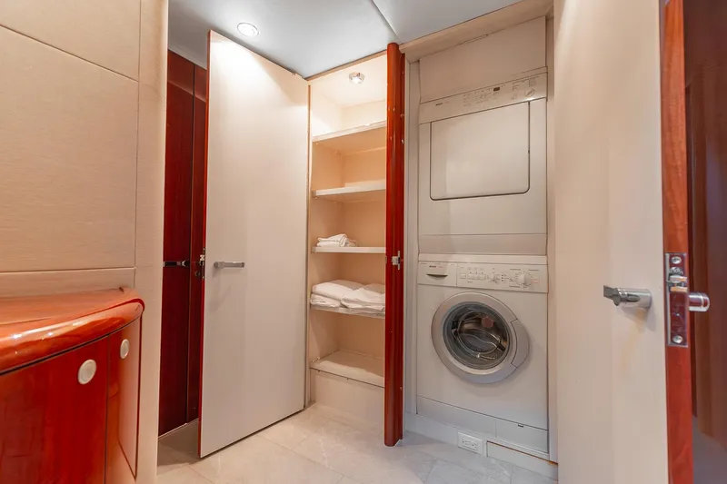 Slide: The Image of Laundry area with stacked washer and dryer in 2002 Lazzara 80 Skylounge yacht. - 33