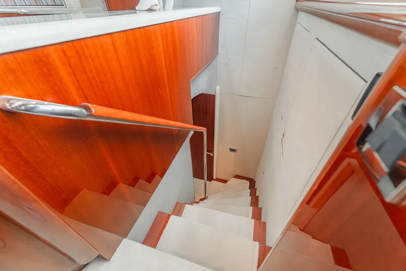 Slide: The Image of Staircase with wooden paneling on a 2002 Lazzara 80 Skylounge yacht interior. - 34