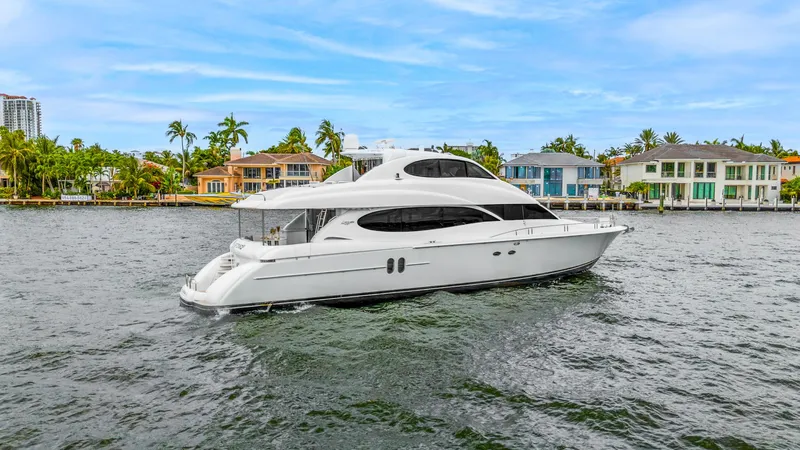 Slide: The Image of Luxury 2002 Lazzara 80 Skylounge yacht cruising near waterfront homes. - 4