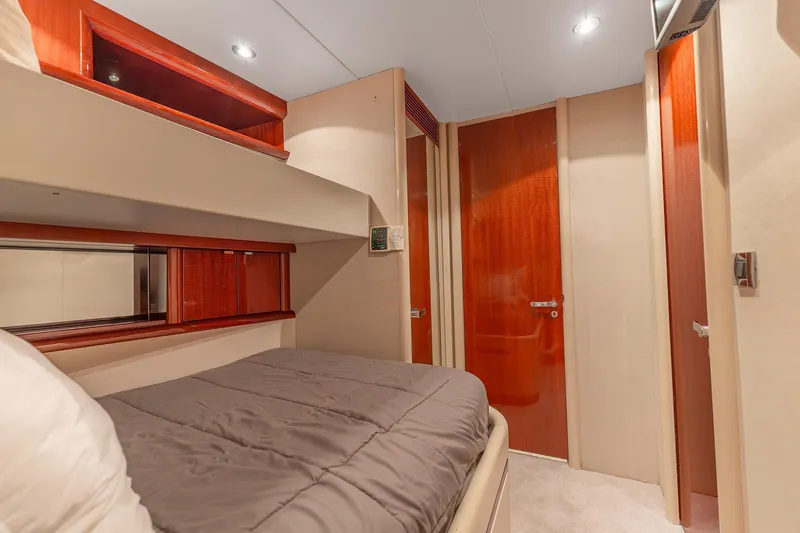 Slide: The Image of Luxurious cabin interior of 2002 Lazzara 80 Skylounge yacht with wood accents and cozy bedding. - 40