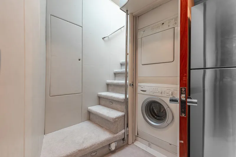 Slide: The Image of Laundry area with washer and dryer in 2002 Lazzara 80 Skylounge yacht. - 43