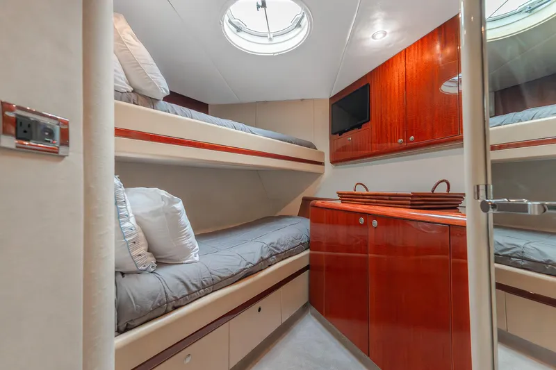 Slide: The Image of Luxurious cabin interior of 2002 Lazzara 80 Skylounge yacht with bunk beds and wood cabinetry. - 48