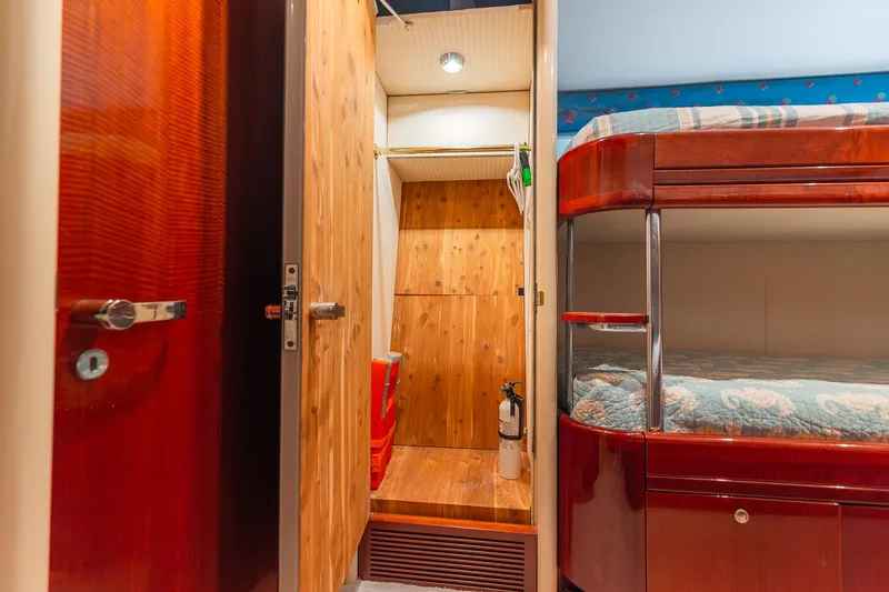 Slide: The Image of Interior of 2002 Lazzara 80 Skylounge yacht with wooden closet and bunk beds. - 57